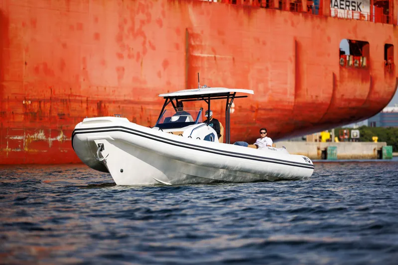 Stock Inventory Yacht Photos Pics 2024 Nuova Jolly Prince 38 boat cruising near a large cargo ship.
