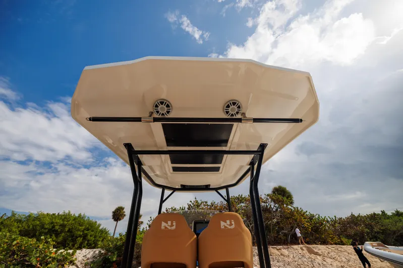 Stock Inventory Yacht Photos Pics Nuova Jolly Prince 38 boat canopy, 2024 model, with speakers, under a partly cloudy sky.