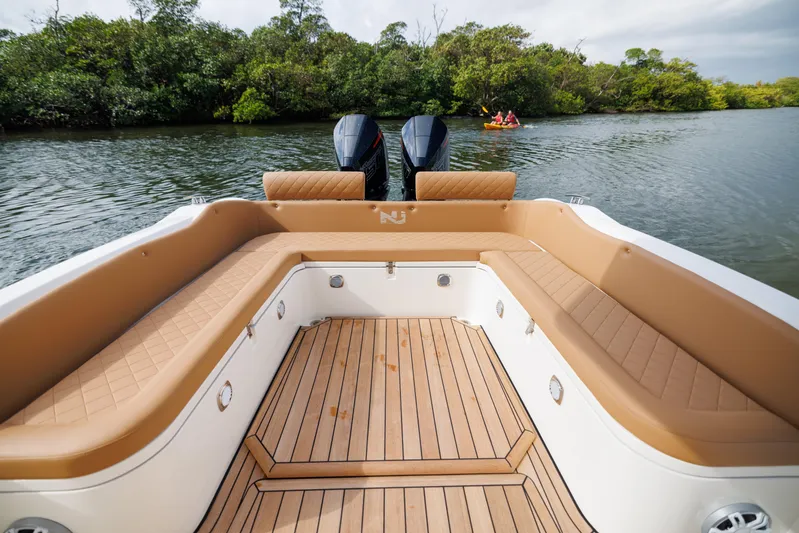 Stock Inventory Yacht Photos Pics 2024 Nuova Jolly Prince 38 boat with spacious seating and dual engines on a serene river.