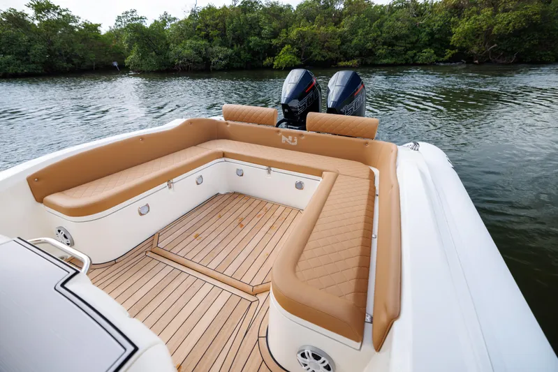 Stock Inventory Yacht Photos Pics 2024 Nuova Jolly Prince 38 boat with tan seating and twin engines on a calm river.