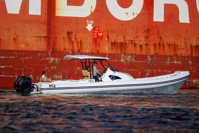 Stock Inventory Yacht Photos Pics Nuova Jolly Prince 38 boat, 2024 model, cruising near a large ship.