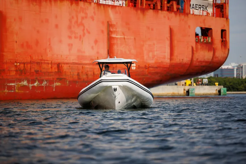 Stock Inventory Yacht Photos Pics Nuova Jolly Prince 38 boat, 2024 model, cruising near a large cargo ship.