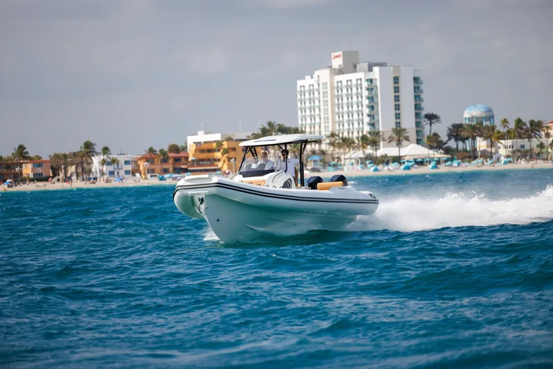 Stock Inventory Yacht Photos Pics 2024 Nuova Jolly Prince 38 boat cruising near a coastal cityscape.