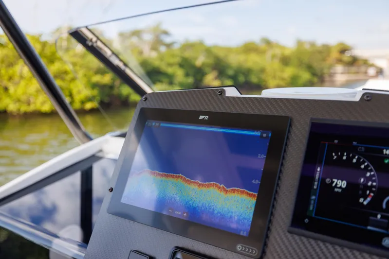 Stock Inventory Yacht Photos Pics 2024 Nuova Jolly Prince 38 dashboard with navigation display, near lush greenery.