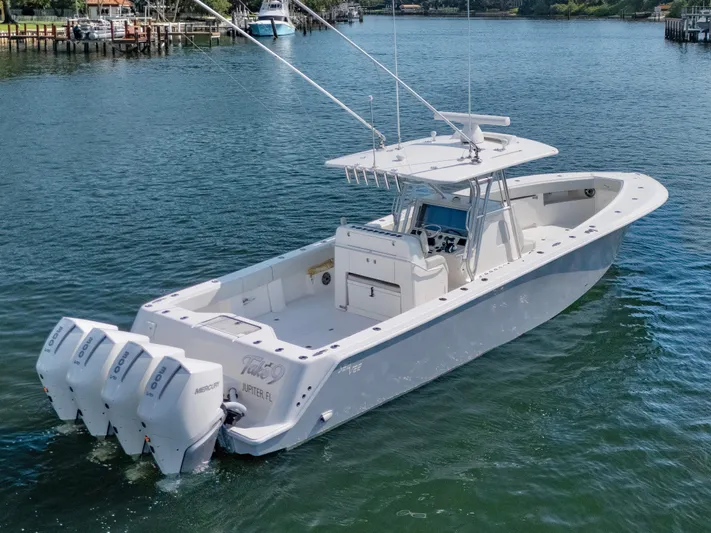  Yacht Photos Pics 2024 SeaVee 390B boat with four engines on a calm waterway.