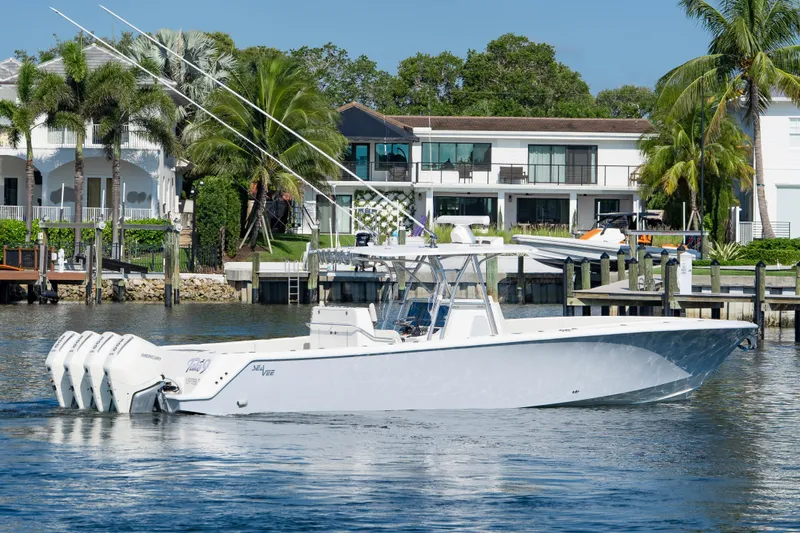  Yacht Photos Pics 2024 SeaVee 390B boat on water near luxury waterfront homes.