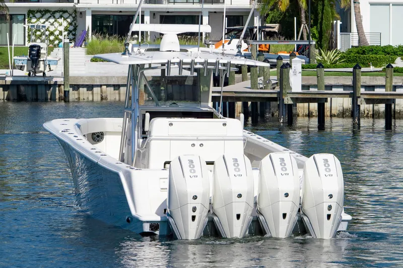  Yacht Photos Pics 2024 SeaVee 390B boat with quad outboard engines docked in a marina.