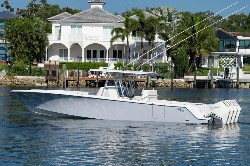  Yacht Photos Pics 2024 SeaVee 390B boat on water near luxury waterfront homes.