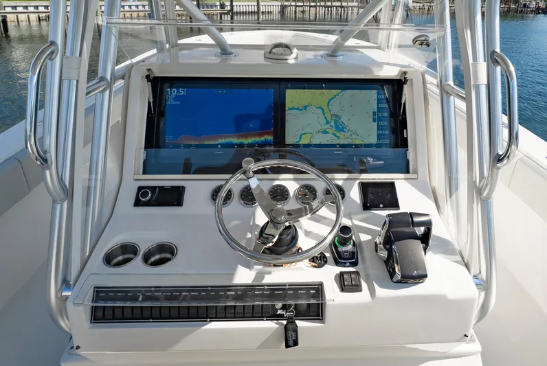  Yacht Photos Pics 2024 SeaVee 390B boat dashboard with dual navigation screens and steering wheel.