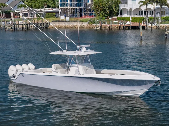  Yacht Photos Pics 2024 SeaVee 390B boat on calm water, featuring sleek design and multiple outboard engines.
