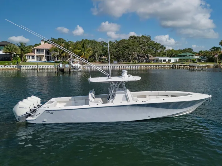  Yacht Photos Pics 2024 SeaVee 390B boat on calm water, featuring sleek design and powerful engines.
