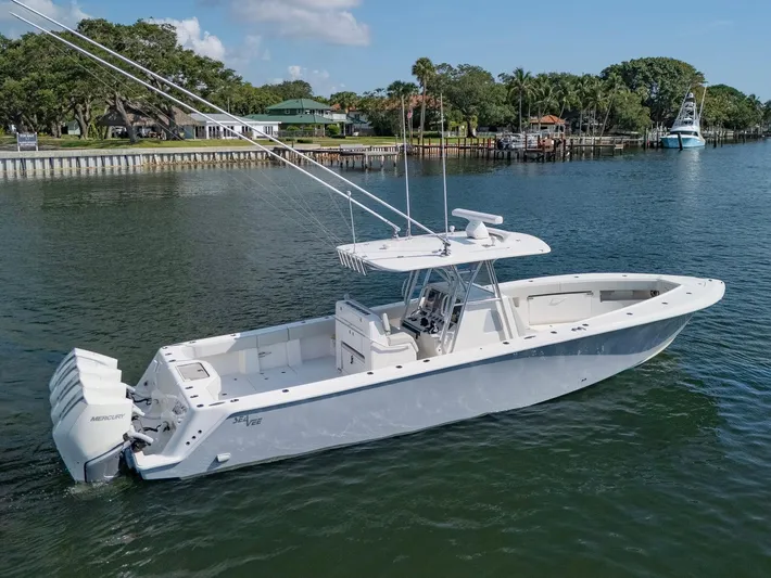  Yacht Photos Pics 2024 SeaVee 390B boat on calm water, featuring sleek design and powerful engines.