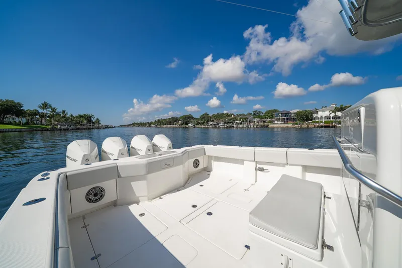  Yacht Photos Pics 2024 SeaVee 390B boat with quad engines on a sunny day, scenic waterfront view.