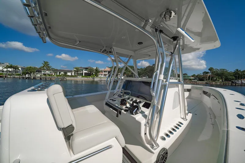  Yacht Photos Pics 2024 SeaVee 390B boat interior with helm, sleek design, and waterfront view.