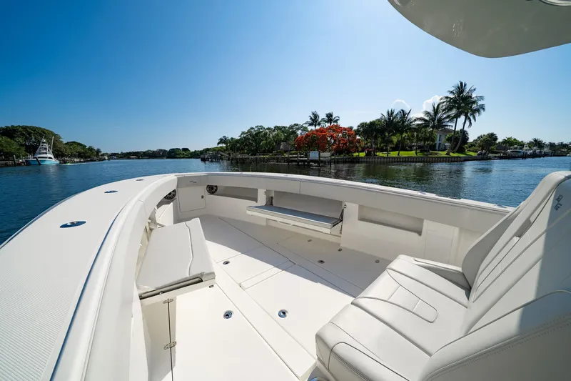  Yacht Photos Pics 2024 SeaVee 390B boat interior with seating, overlooking a scenic waterfront view.