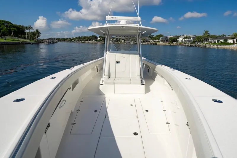  Yacht Photos Pics 2024 SeaVee 390B boat on calm water, showcasing spacious deck and sleek design.