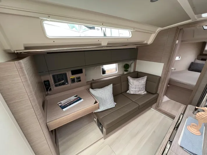 Mdr 388 #305 In Stock Yacht Photos Pics Modern interior of 2023 Hanse 388 yacht with cozy seating and navigation station.