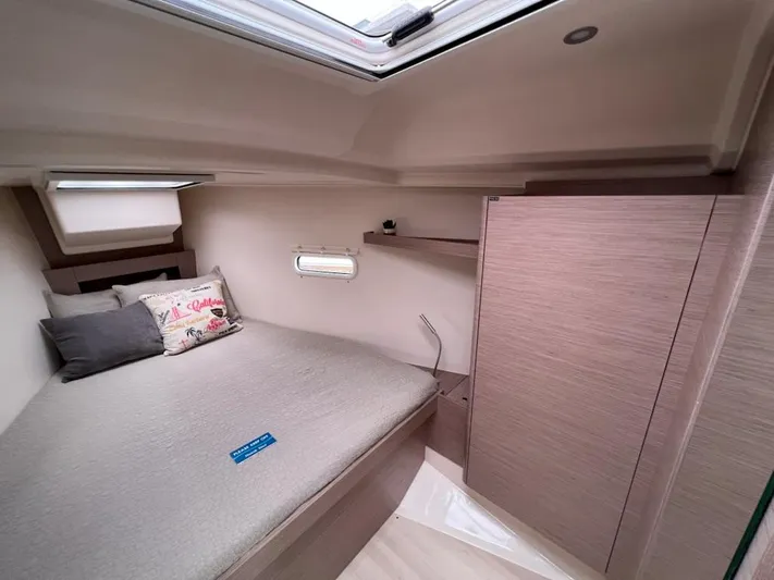 Mdr 388 #305 In Stock Yacht Photos Pics 2023 Hanse 388 yacht interior cabin with bed, pillows, and storage.