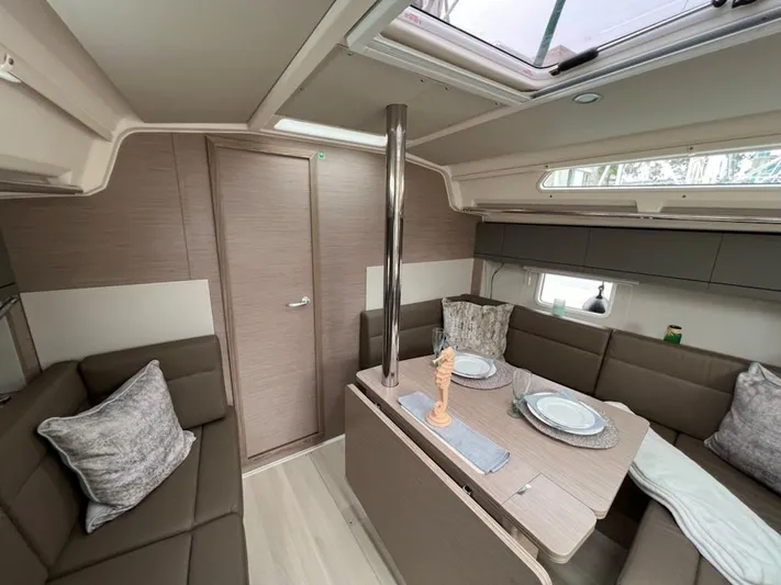 Mdr 388 #305 In Stock Yacht Photos Pics Interior of 2023 Hanse 388 sailboat with modern dining area and skylight.