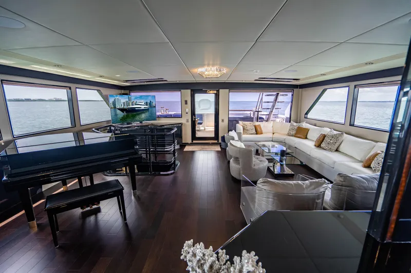 Quantum Yacht Photos Pics Luxurious interior of 1989 Broward Tri-Deck yacht with panoramic windows and elegant furnishings.