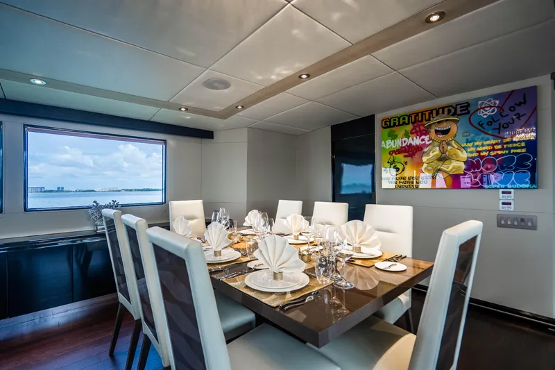 Quantum Yacht Photos Pics Luxurious dining area on a 1989 Broward Tri-Deck yacht with modern decor.