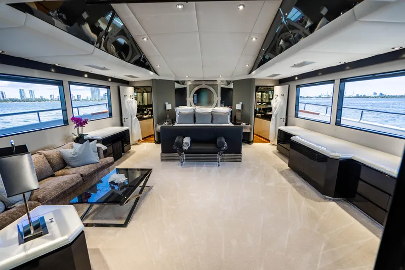 Quantum Yacht Photos Pics Luxurious interior of a 1989 Broward Tri-Deck yacht with modern furnishings and panoramic windows.