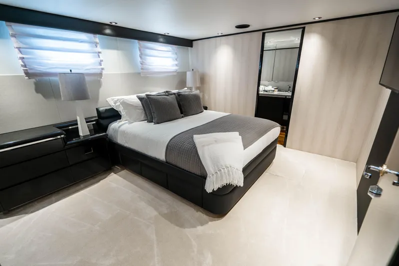Quantum Yacht Photos Pics Luxurious bedroom on a 1989 Broward Tri-Deck yacht with modern decor.