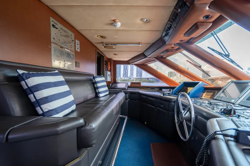 Quantum Yacht Photos Pics 1989 Broward Tri-Deck yacht interior with leather seating and navigation controls.