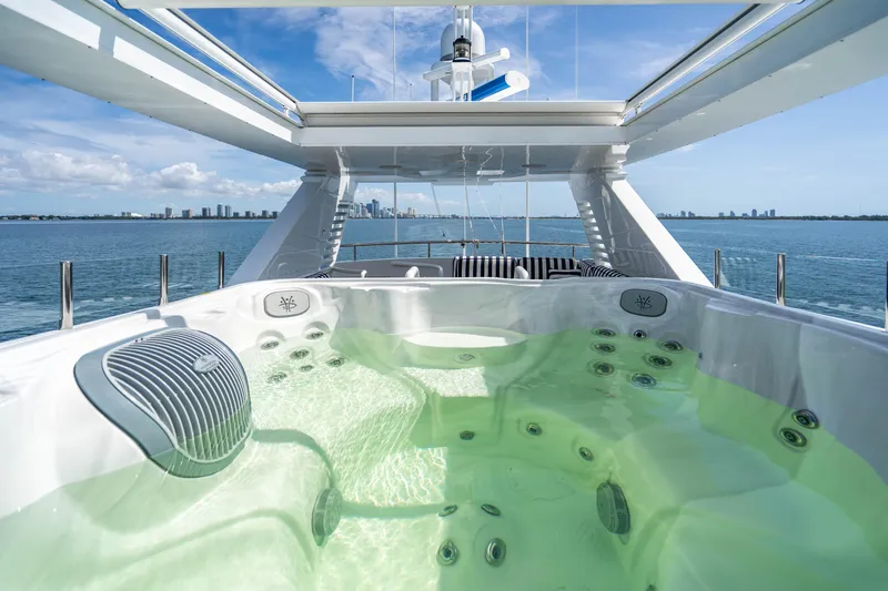 Quantum Yacht Photos Pics Luxurious hot tub on the deck of a 1989 Broward Tri-Deck yacht with ocean view.