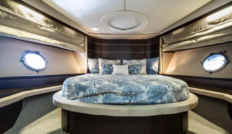 Lunsea Yacht Photos Pics Luxurious bedroom interior of 2005 Azimut 68S yacht with elegant bedding and porthole windows.