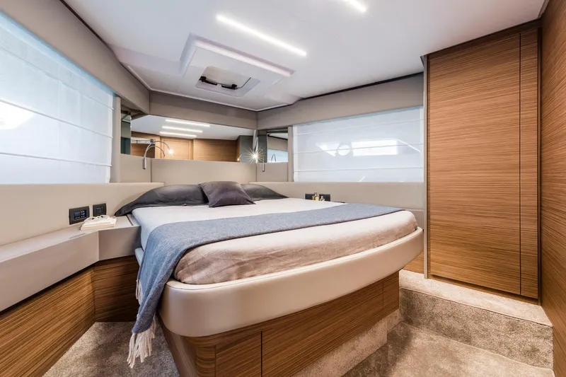 Yacht Photos Pics Luxurious bedroom interior of 2020 Ferretti Yachts 450, featuring modern design and cozy ambiance.
