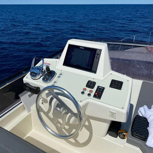  Yacht Photos Pics Helm of 2020 Ferretti Yachts 450 with navigation controls, steering wheel, and ocean view.