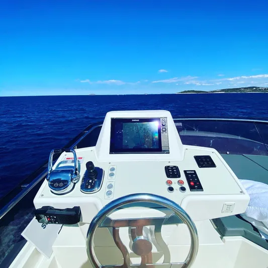  Yacht Photos Pics Helm of 2020 Ferretti Yachts 450 with navigation controls, overlooking the ocean.