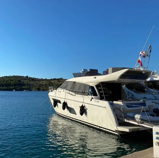  Yacht Photos Pics 2020 Ferretti Yachts 450 docked in a serene marina setting.