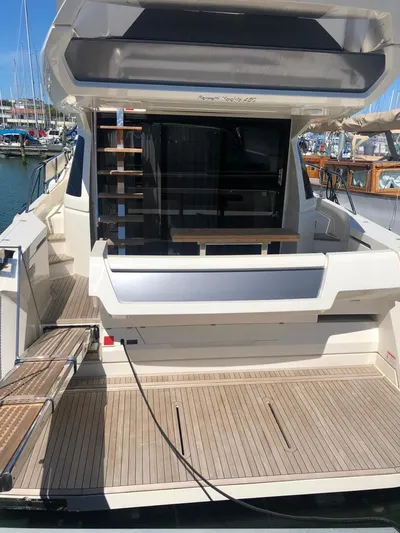  Yacht Photos Pics Ferretti Yachts 450, 2020 model, rear view with open deck and marina background.