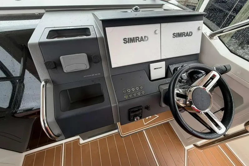 Dirty Money Yacht Photos Pics 2021 Nimbus T-11 boat dashboard with Simrad displays and steering wheel.