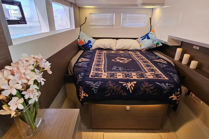  Yacht Photos Pics Luxurious bedroom interior of 2023 Leopard 40 Powercat with floral decor and cozy bedding.