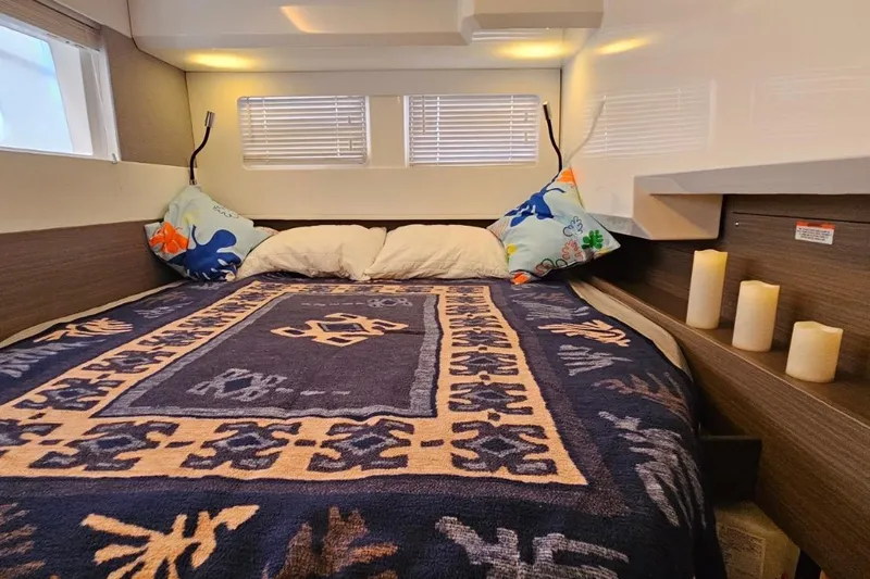  Yacht Photos Pics Luxurious bedroom interior of 2023 Leopard 40 Powercat with cozy bedding and decorative pillows.