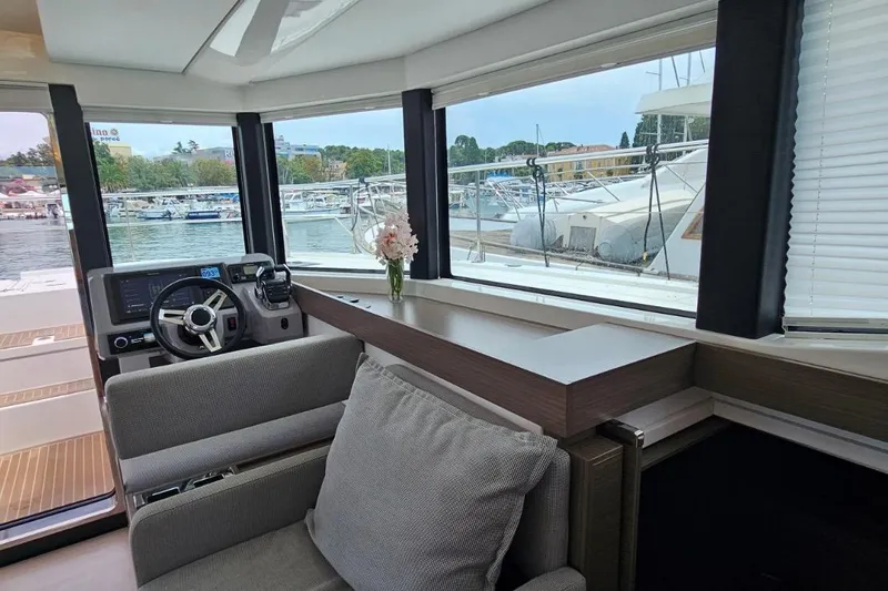  Yacht Photos Pics Interior of 2023 Leopard 40 Powercat yacht with helm, seating, and marina view.