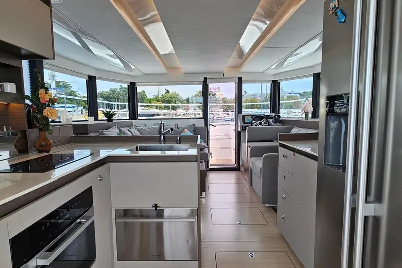  Yacht Photos Pics 2023 Leopard 40 Powercat interior with modern kitchen, spacious seating, and panoramic windows.