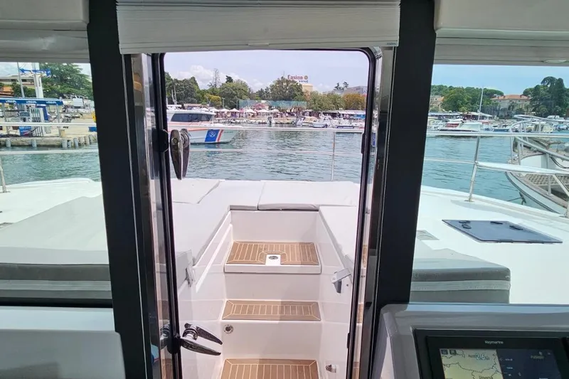  Yacht Photos Pics 2023 Leopard 40 Powercat interior view with marina backdrop.