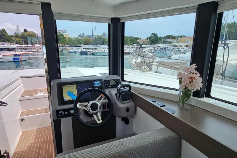  Yacht Photos Pics Interior view of 2023 Leopard 40 Powercat helm with navigation display and floral decor.