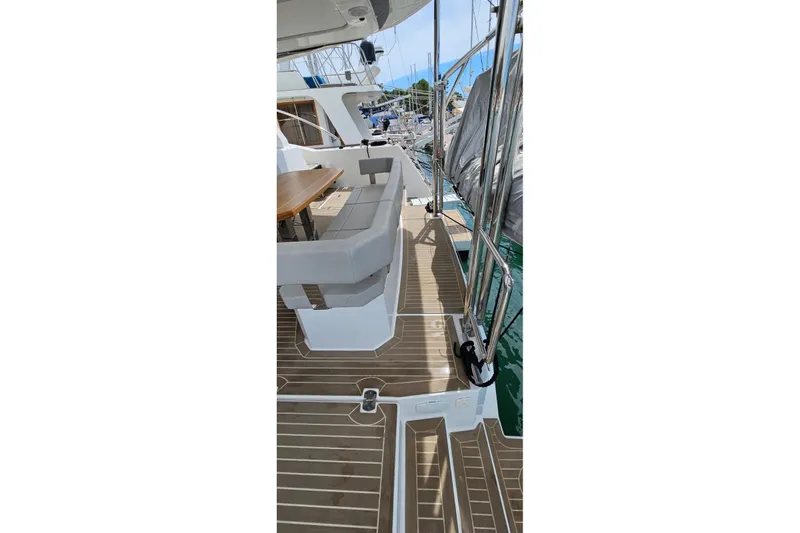  Yacht Photos Pics 2023 Leopard 40 Powercat deck with seating and table, docked at marina.