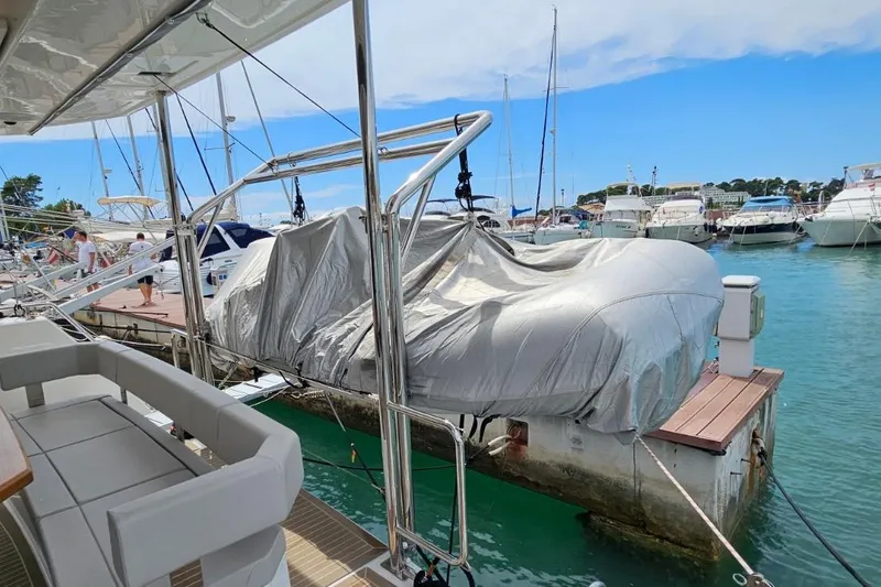  Yacht Photos Pics 2023 Leopard 40 Powercat docked, featuring covered equipment and marina view.