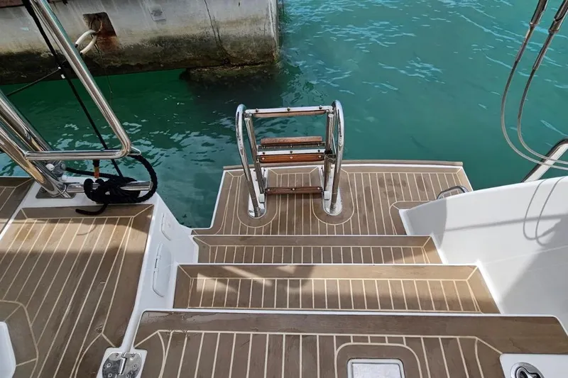  Yacht Photos Pics 2023 Leopard 40 Powercat swim platform with ladder, docked in turquoise water.