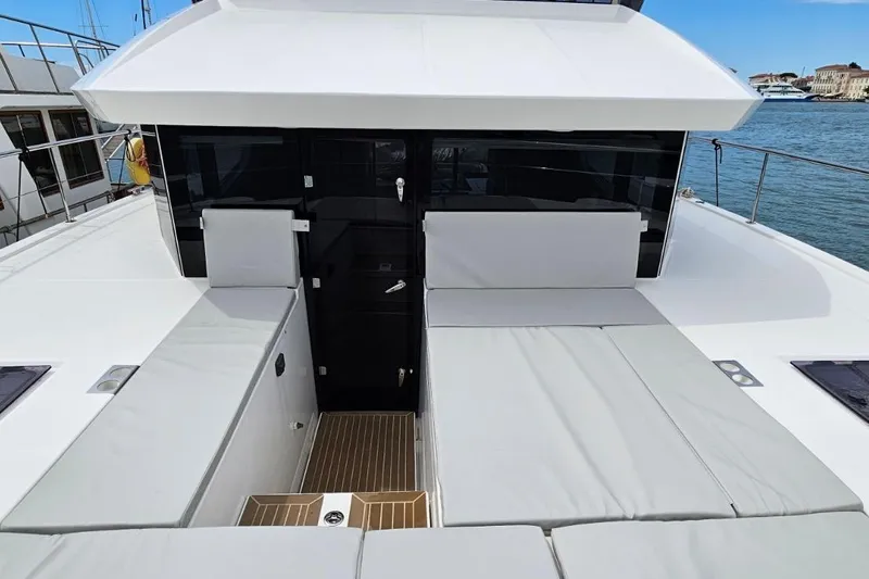  Yacht Photos Pics 2023 Leopard 40 Powercat yacht deck with cushioned seating and sleek design.