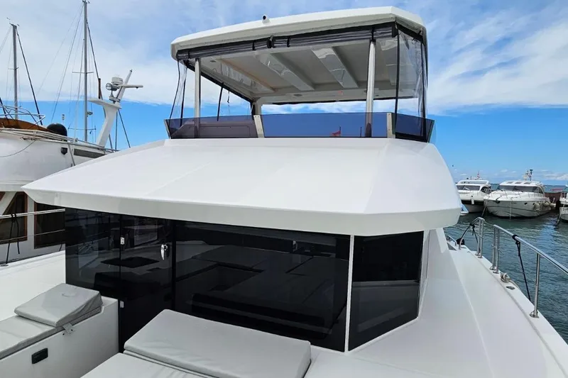  Yacht Photos Pics 2023 Leopard 40 Powercat yacht docked at marina under blue sky.