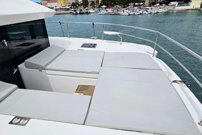  Yacht Photos Pics 2023 Leopard 40 Powercat yacht with spacious sunbathing area, docked in a marina.