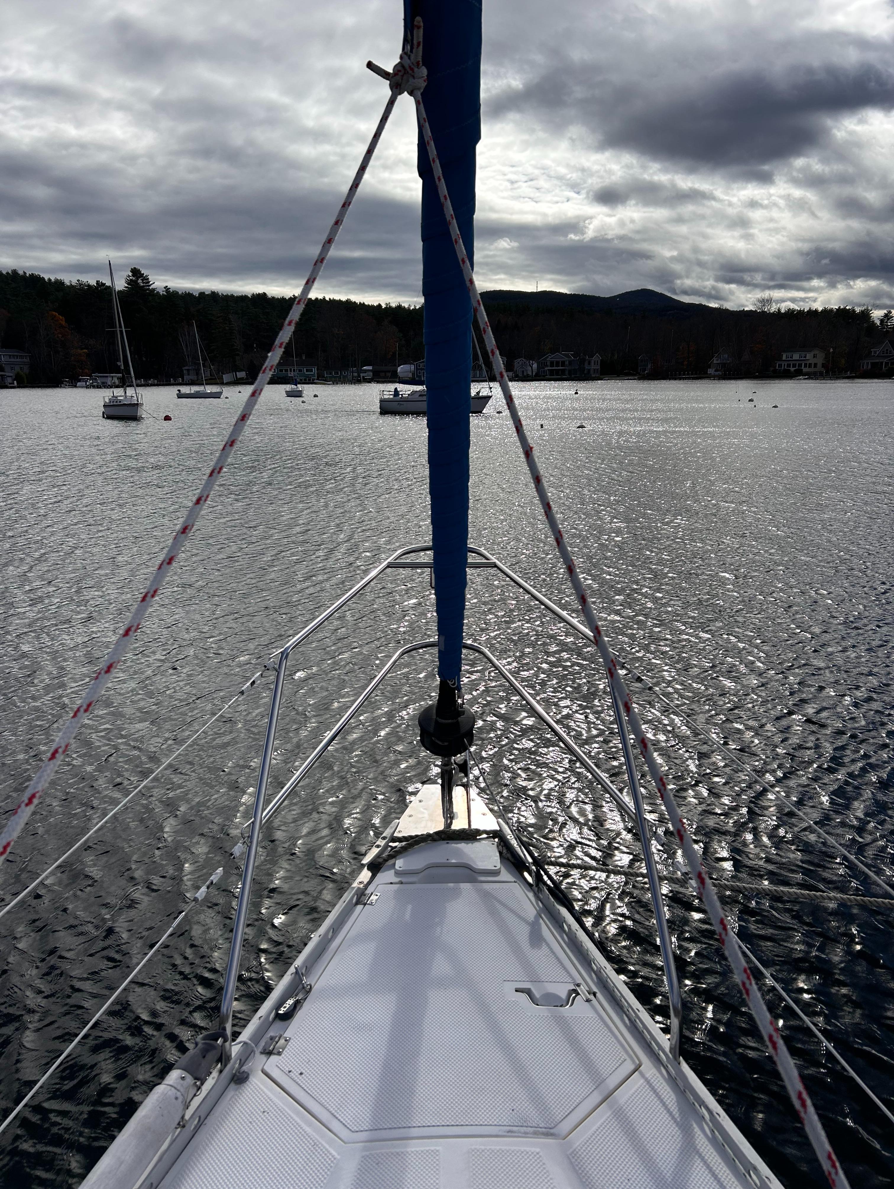 Sailboat on a lake under cloudy skies, Hunter 34 model, 1983.
