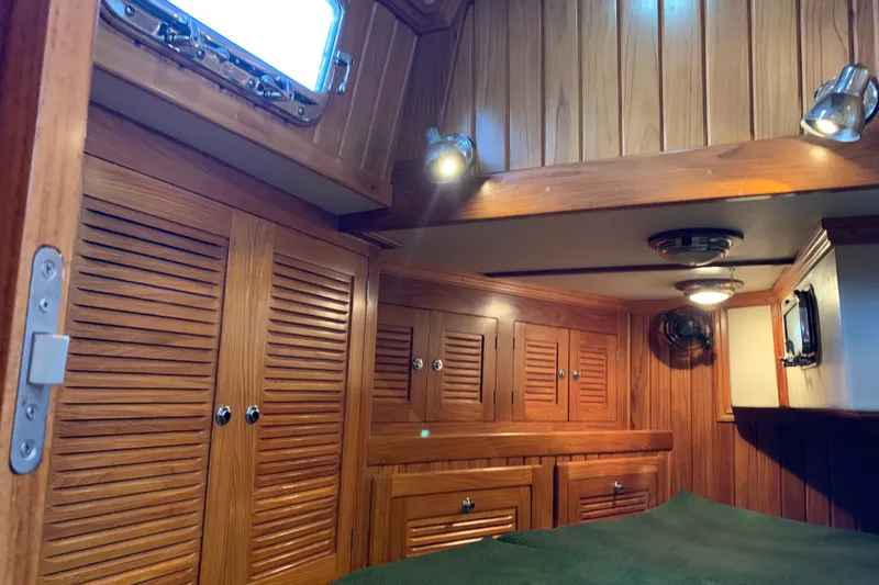 Elation Yacht Photos Pics Interior of 2004 Cabo Rico 42 Pilot yacht with wooden cabinetry and cozy lighting.